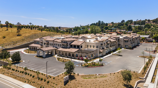 Exterior view of Estancia senior living showing building and parking lot