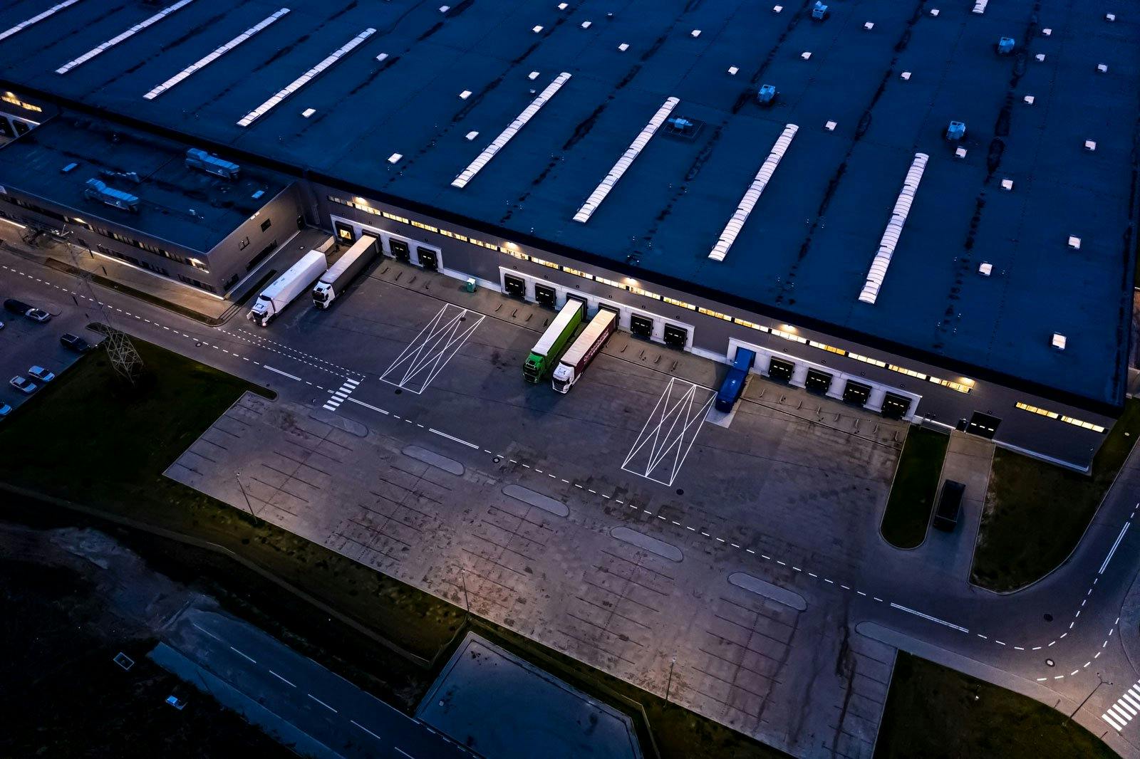 aerial shot of a warehouse showing a loading bay with trucks